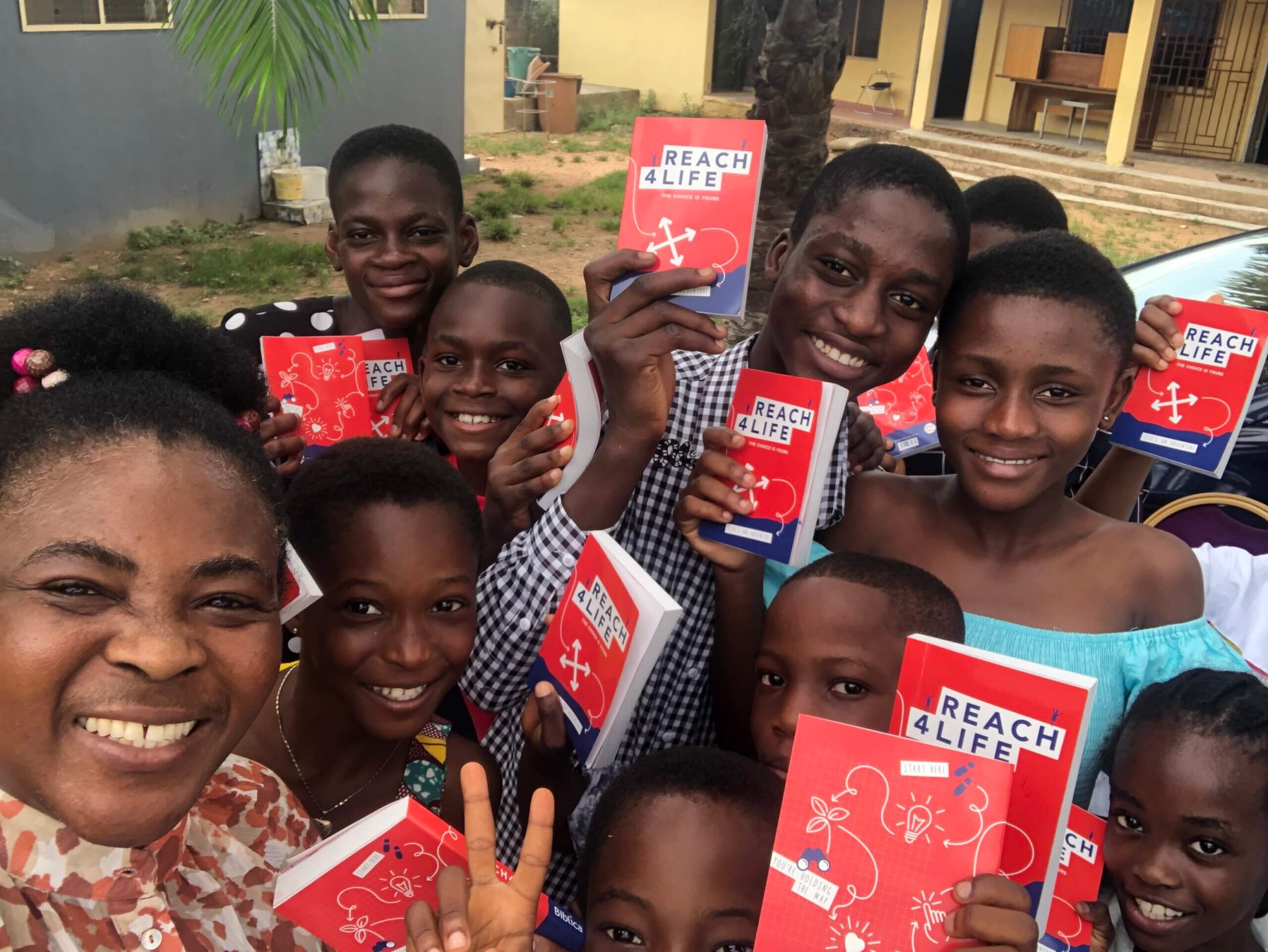 African children holding Reach4Life Bibles